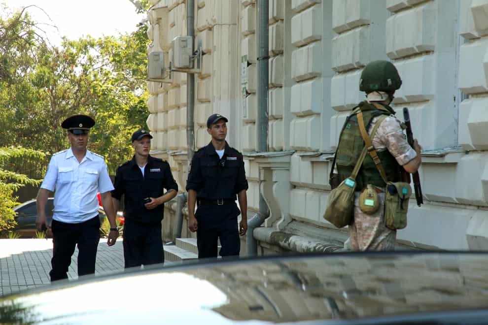 A Russian soldier guards the headquarters of Russia’s Black Sea Fleet in Sevastopol, Crimea, Sunday, July 31, 2022. A drone-borne explosive device detonated Sunday at the headquarters of Russia’s Black Sea Fleet on Sunday, injuring six people, officials said. (AP Photo)