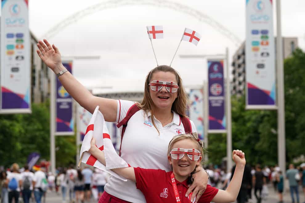 England fans pose for a photo on Wembley Way (Joe Giddens/PA)