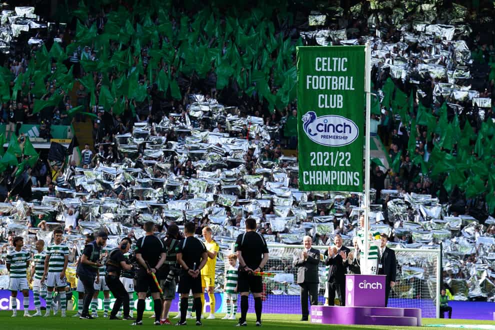 Celtic’s Callum McGregor unfurls the championship flag before win over Aberdeen (Andrew Milligan/PA)