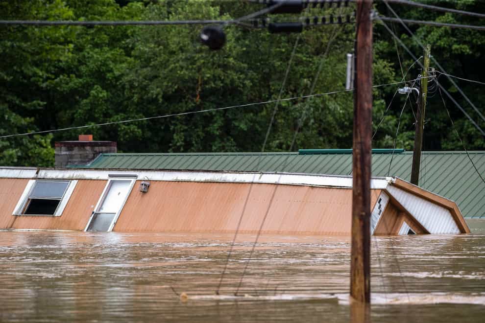 Homes are flooded by Lost Creek, Ky., on Thursday, July 28, 2022. Heavy rains have caused flash flooding and mudslides as storms pound parts of central Appalachia. Kentucky Gov. Andy Beshear says it’s some of the worst flooding in state history. (Ryan C. Hermens/Lexington Herald-Leader via AP)