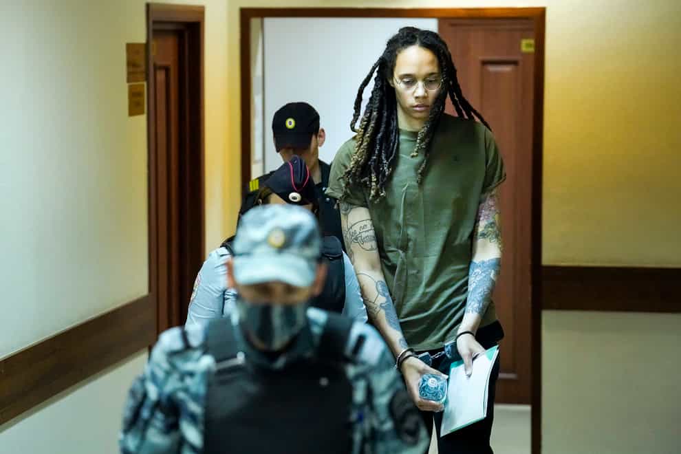 WNBA star and two-time Olympic gold medalist Brittney Griner is escorted to a courtroom prior to a hearing, in Khimki just outside Moscow, Russia, on Tuesday, Aug. 2, 2022 (Alexander Zemlianichenko/AP/PA)
