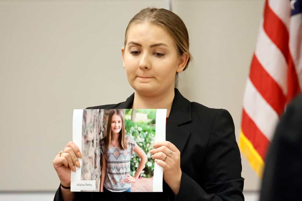 Meghan Petty holds a photograph of her sister, Alaina Petty (Amy Beth Bennett/South Florida Sun Sentinel via AP/PA)