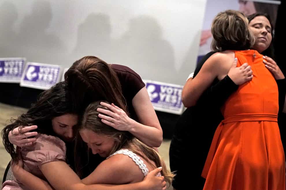 People hug after the result is announced (Charlie Riedel/AP)