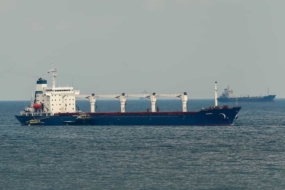 A boat with Russian, Ukrainian, Turkish and UN officials heads to the Sierra Leone-flagged cargo ship Razoni, to check if the grain shipment is in accordance with a crucial agreement signed last month by Moscow and Kyiv, at an inspection area in the Black Sea off the coast of Istanbul, Turkey (Emrah Gurel/AP)