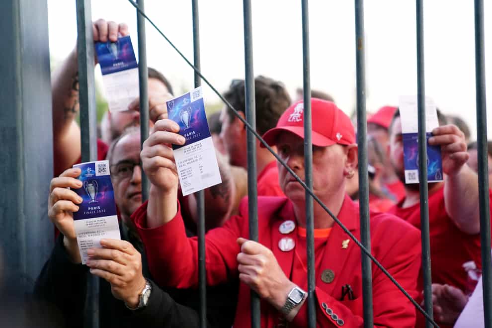 Liverpool fans stuck outside the Stade de France show their tickets (Adam Davy/PA)