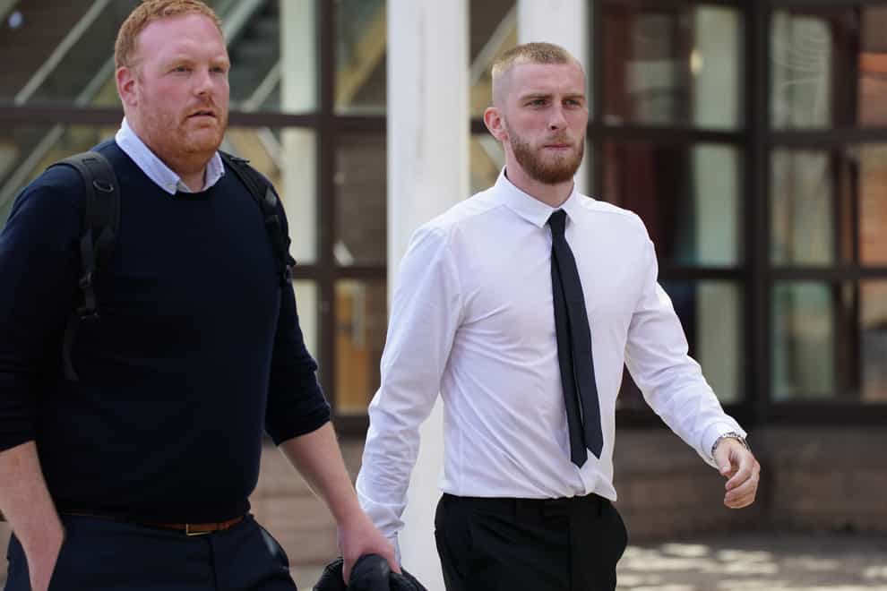 Sheffield United striker Oli McBurnie, right, leaves Nottingham Magistrates’ Court (Jacob King/PA)