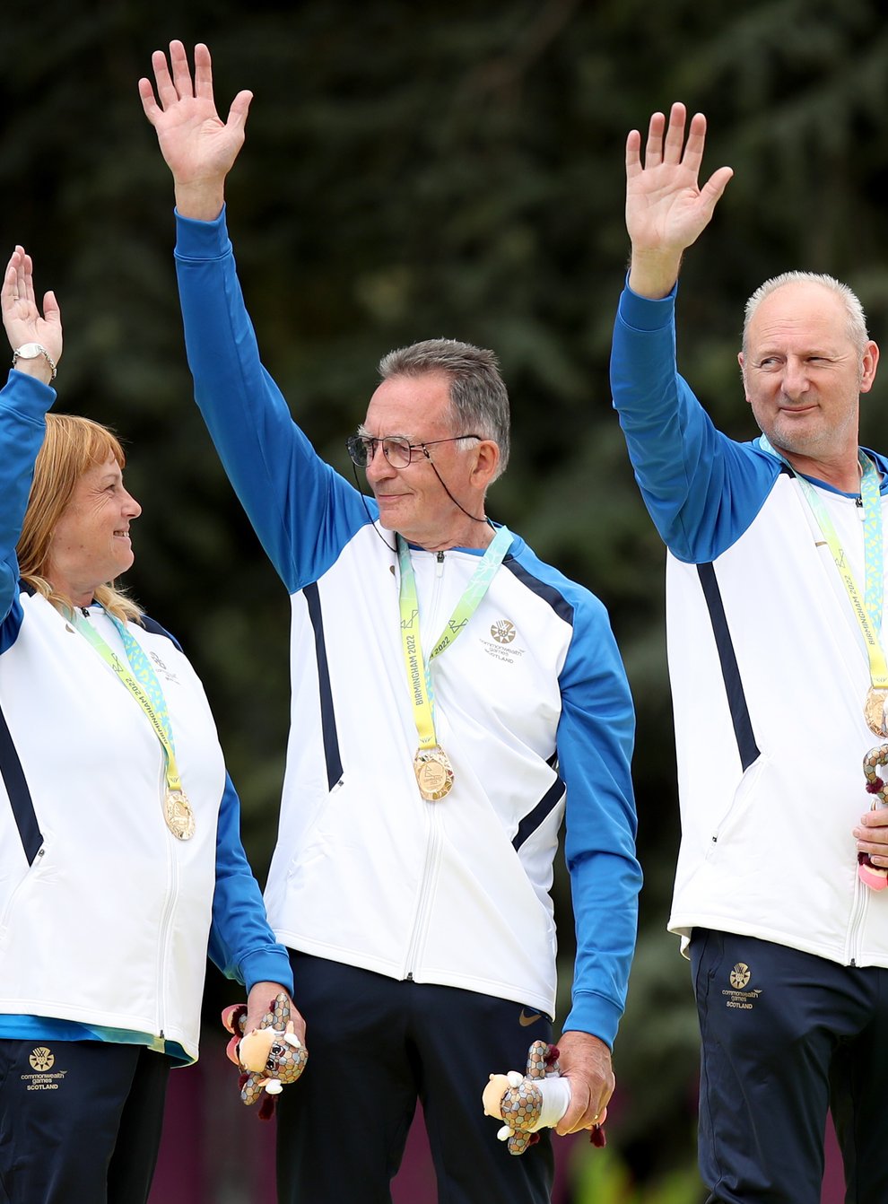 George Miller (second left) celebrates his historic Commonwealth Games gold medal (Isaac Parkin/PA)