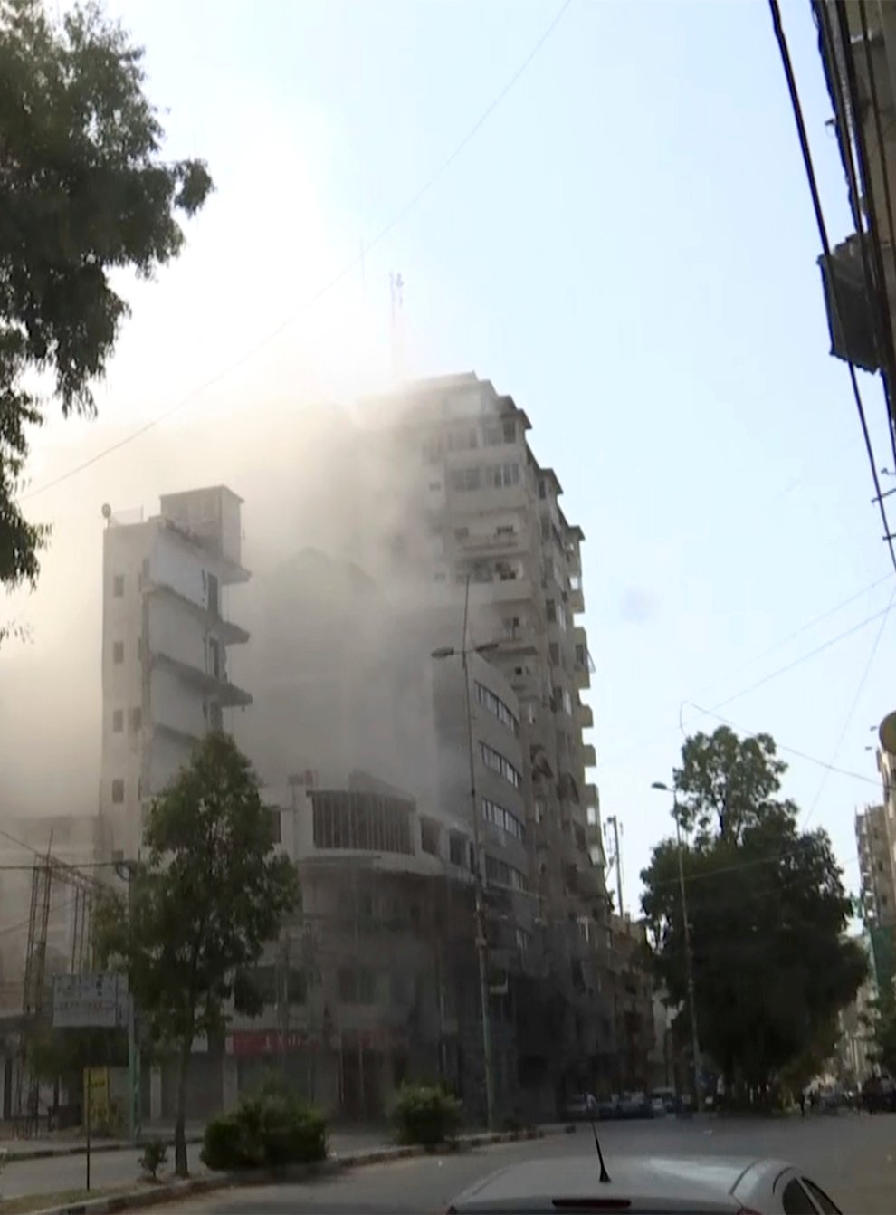 Smoke pours out of a tall building after an Israeli air strikes in Gaza City (AP Photo)