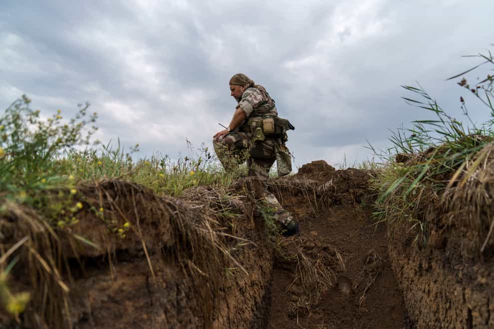 Sgt Maj Artur Shevtsov with the Dnipro-1 regiment exits a bunker at the unit’s position near Sloviansk, Donetsk region, eastern Ukraine (David Goldman/AP)