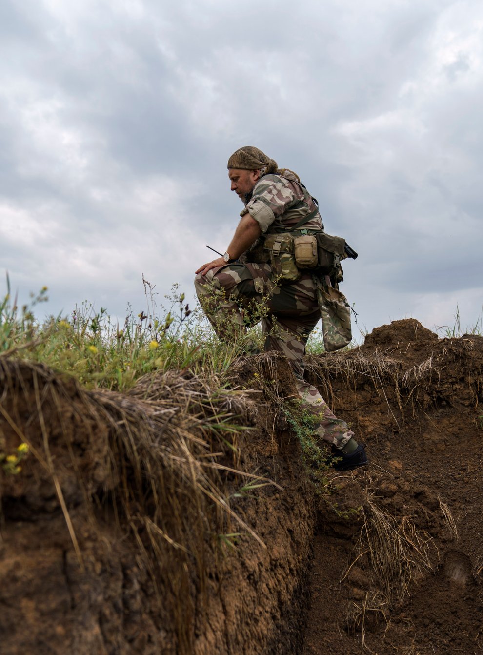 Sgt Maj Artur Shevtsov with the Dnipro-1 regiment exits a bunker at the unit’s position near Sloviansk, Donetsk region, eastern Ukraine (David Goldman/AP)