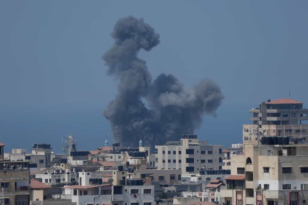 Smoke rises following Israeli air strikes on a building in Gaza City (Hatem Moussa/AP)
