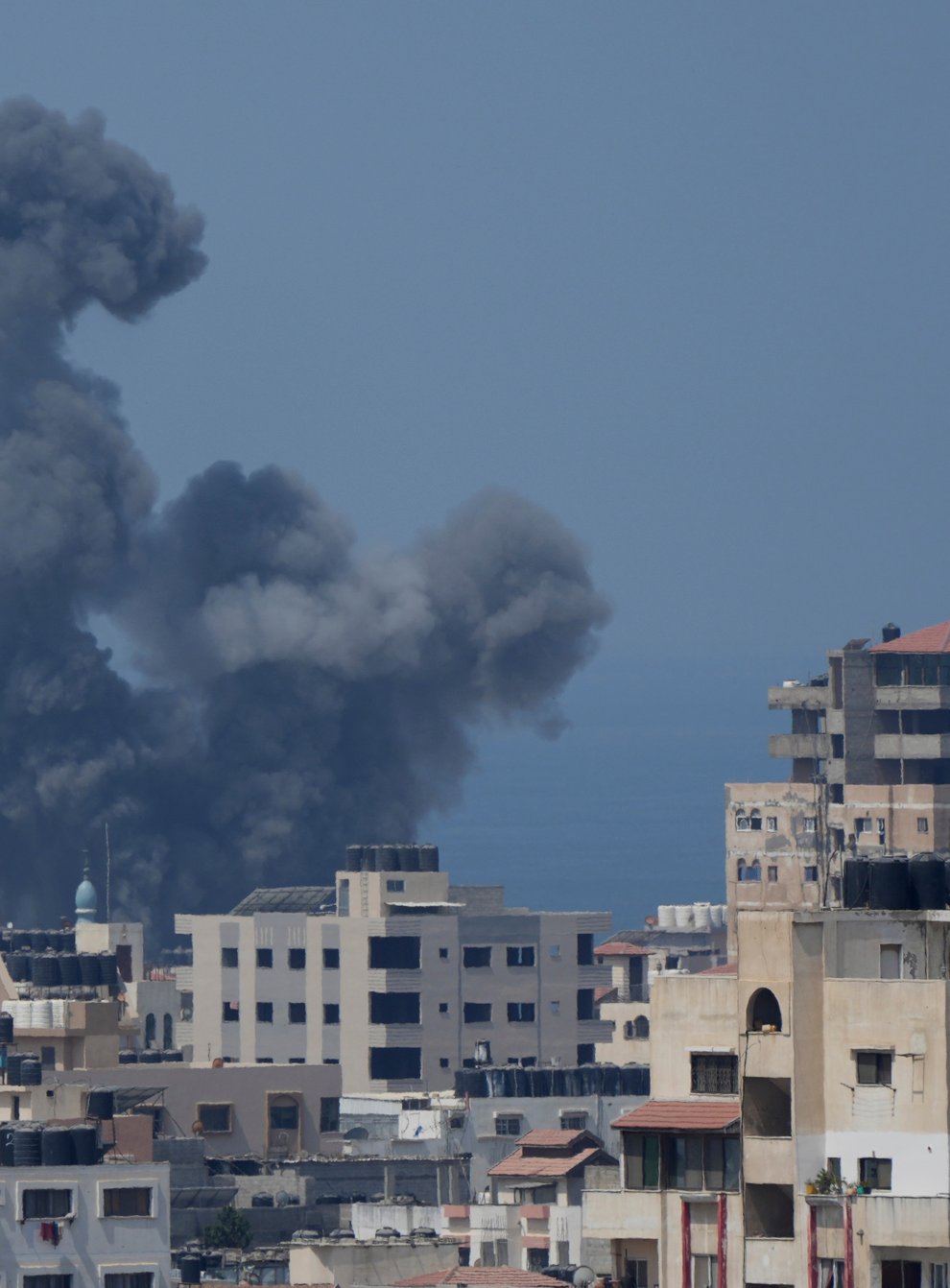 Smoke rises following Israeli air strikes on a building in Gaza City (Hatem Moussa/AP)