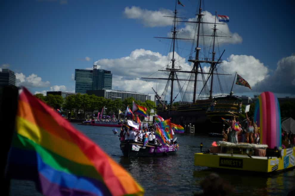 Boats line up for the start as thousands of people lined canals in the Dutch capital to watch the colourful spectacle of the Pride Canal Parade in Amsterdam, Netherlands (Peter Dejong/AP)