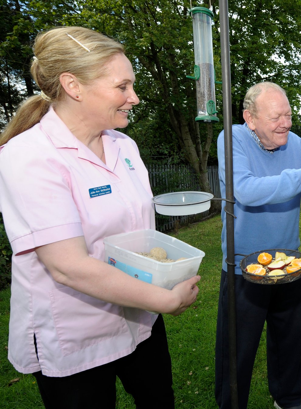(l-r) Julie-Ann McStravick, care home residents Bob Richardson and David Duprey and Peter Harper of the Lough Neagh Partnership fill one of the bird feeders(Edward Byrne/PA)