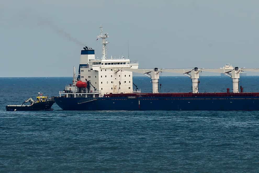 A boat with Russian, Ukrainian, Turkish and U.N. officials heads to the Sierra Leone-flagged cargo ship Razoni, to check if the grain shipment is in accordance with a crucial agreement signed last month by Moscow and Kyiv, at an inspection area in the Black Sea off the coast of Istanbul, Turkey, Wednesday, Aug. 3, 2022. The cargo ship Razoni, loaded up with 26,000 tons of corn, set sail from Ukraine’s Odesa on Monday, enroute to final destination, Lebanon.(AP Photo/Emrah Gurel)