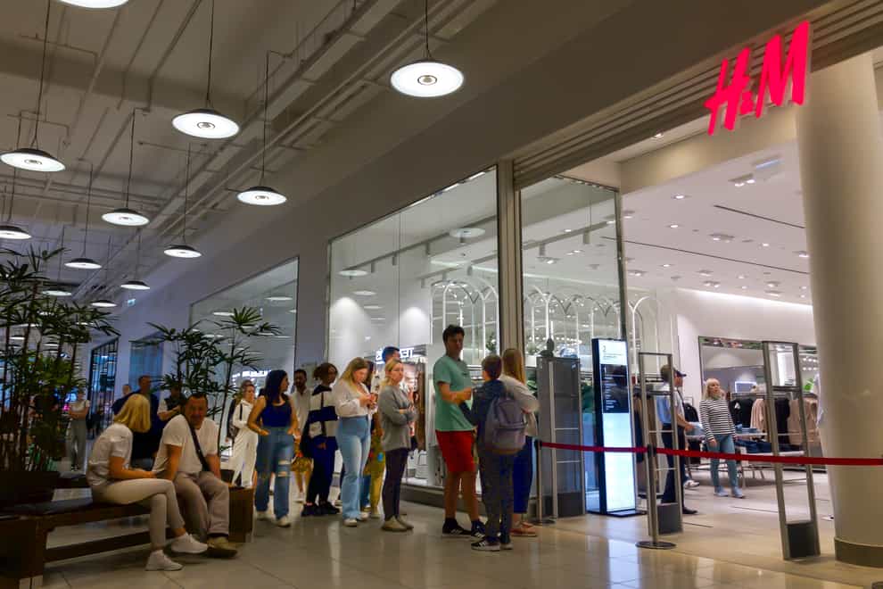 People line up to enter an H&M shop and buy items on sale in the Aviapark shopping centre in Moscow, Russia, on Tuesday August 9 2022 (Alexander Zemlianichenko/AP)