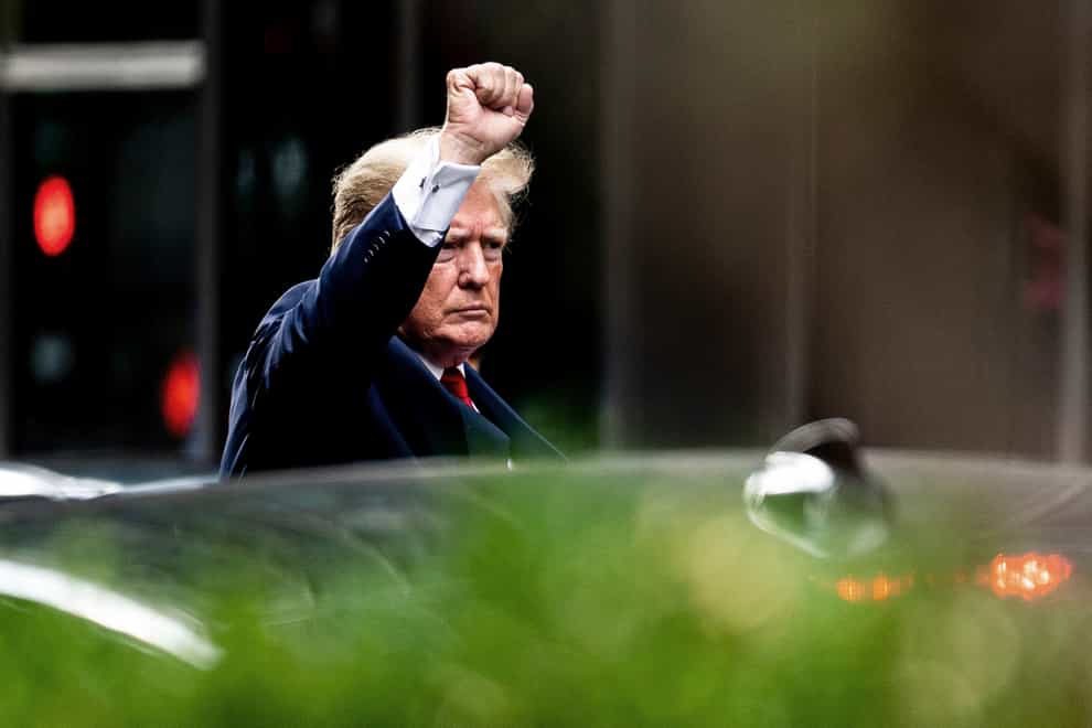 Former US president Donald Trump gestures as he departs Trump Tower on Wednesday August 10 2022 in New York (Julia Nikhinson/AP)