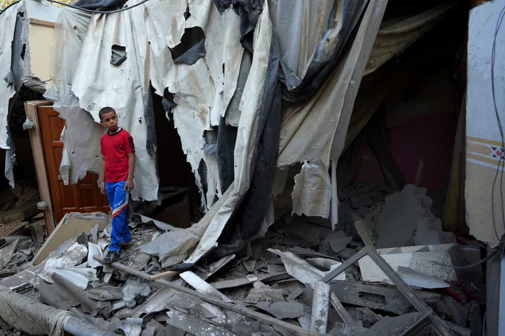 Mohammad Arada looks at the rubble of his family house after it was destroyed by an Israeli airstrike, in Rafah refugee camp, southern Gaza Strip (Adel Hana/AP)