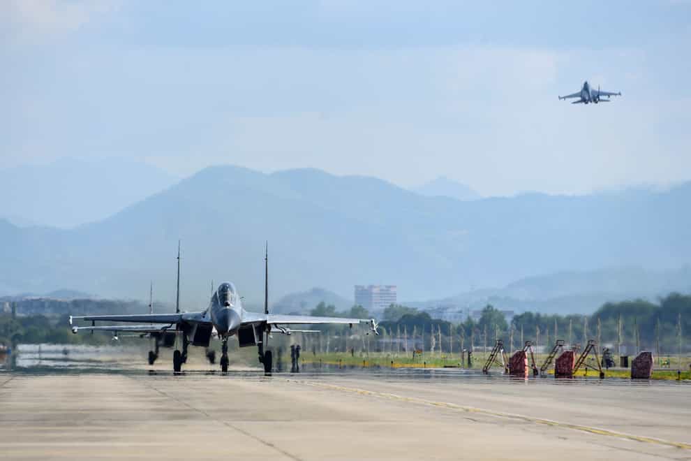 Air force and naval aviation corps of the Eastern Theatre Command of the Chinese People’s Liberation Army fly planes at an unspecified location in China (Xinhua via AP)File)