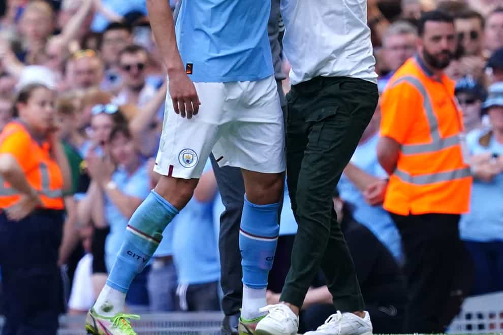 Manchester City manager Pep Guardiola greets Erling Haaland (Martin Rickett/PA)