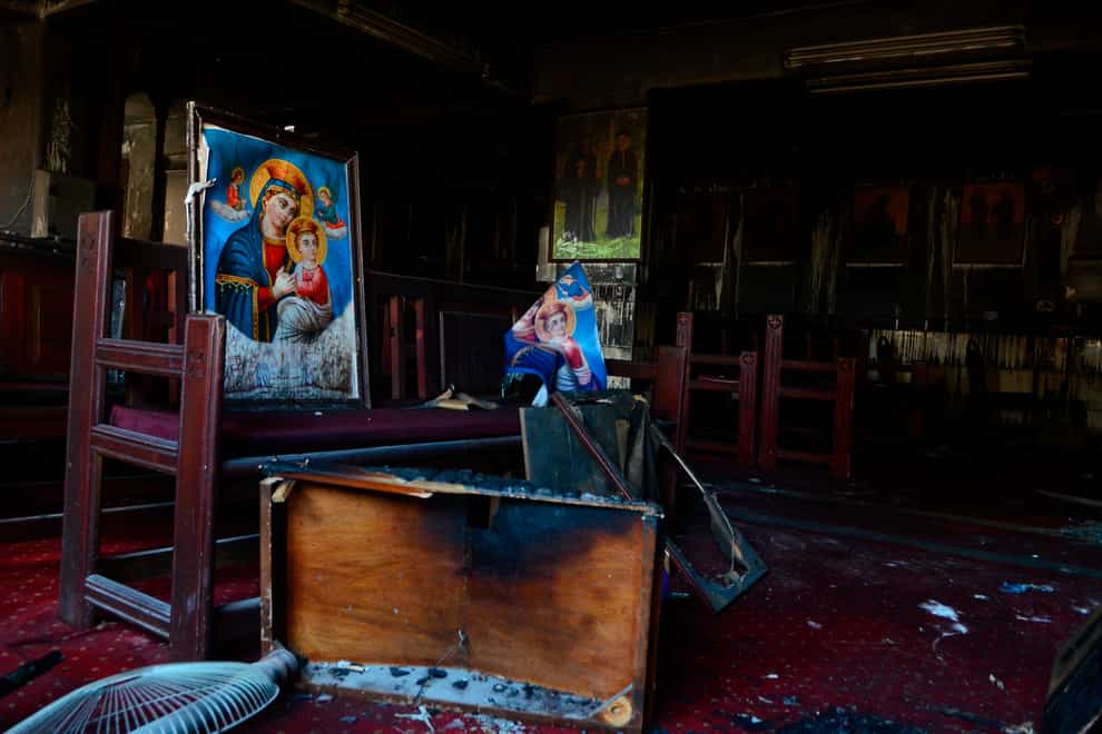 Burned furniture, including wooden tables and chairs, and religious imagery are seen at the site of the fire (Tarek Wajeh/AP)