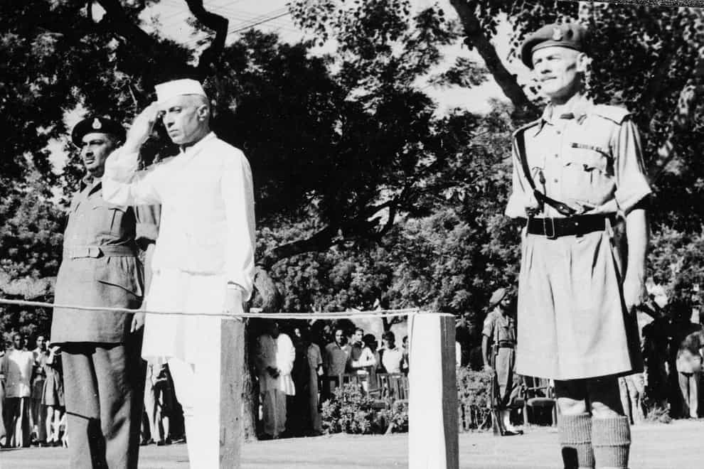 Jawaharlal Nehru salutes the flag as he becomes independent India’s first prime minister on August 15 (AP)