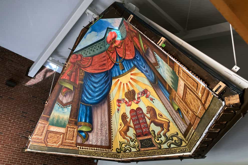 The mural painted in 1910 by a Lithuanian immigrant, that was later hidden behind a wall for years, has been rehabilitated and moved and is what experts say is a rare piece of art (Lisa Rathke/AP/PA)