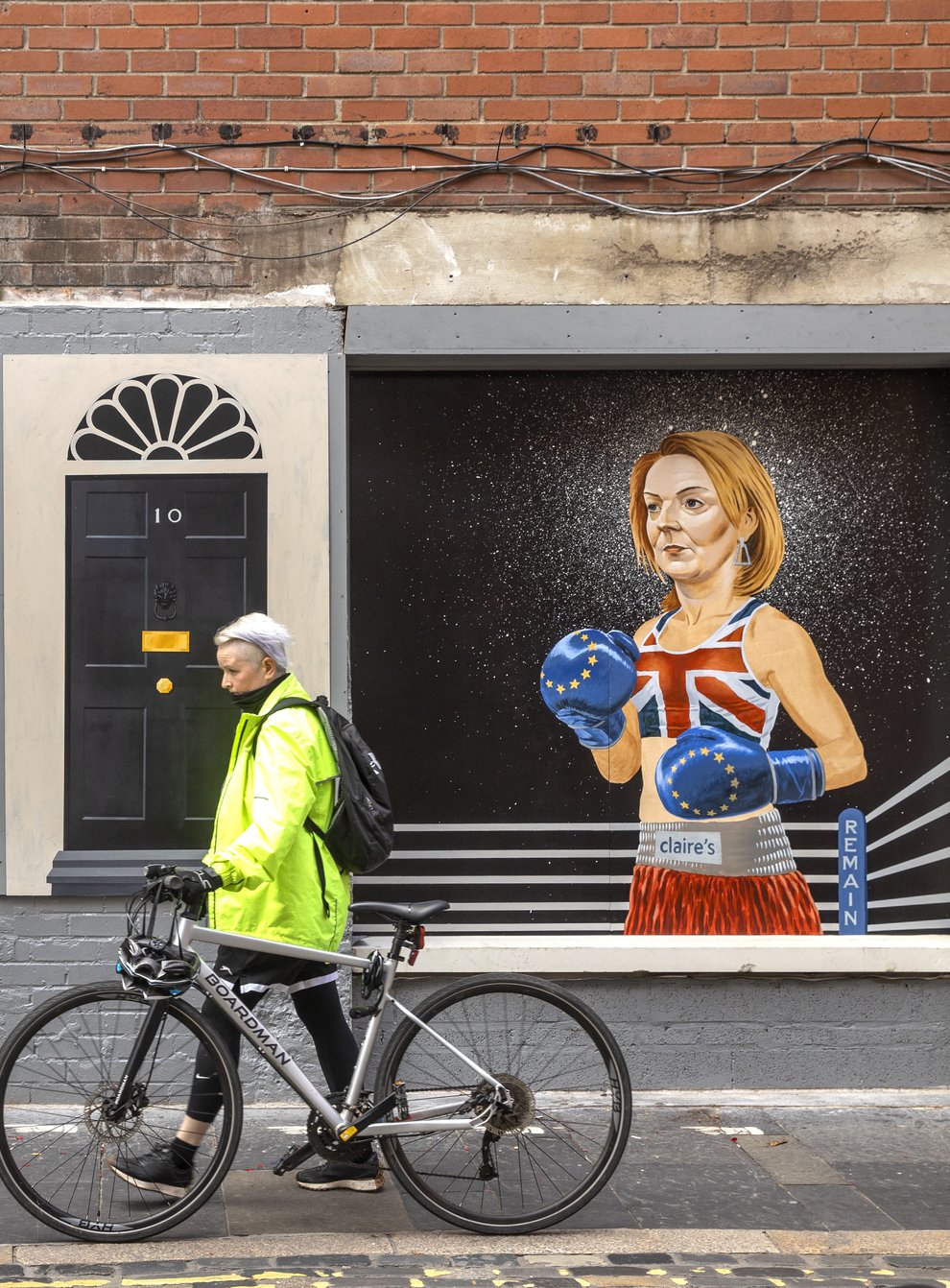 A women walks past a mural on Hill Street in Belfast by Ciaran Gallagher Art (PA)