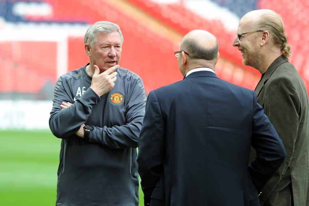 Sir Alex Ferguson talking to directors Joel Glazer (second right) and Avram Glazer (right) during a training session at Wembley in May 2011 (Martin Rickett/PA)