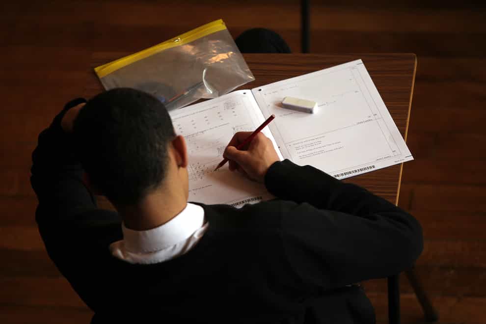 <p>A student doing an exam (David Davies/PA)</p>
