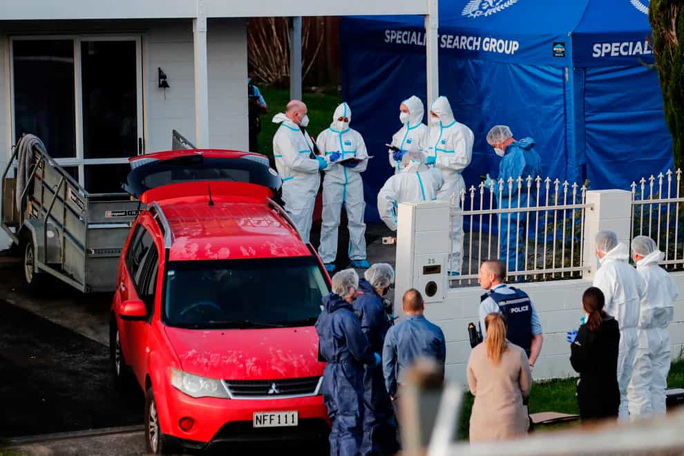 New Zealand police investigators work at a scene in Auckland after bodies were discovered in suitcases (Dean Purcell/New Zealand Herald via AP)