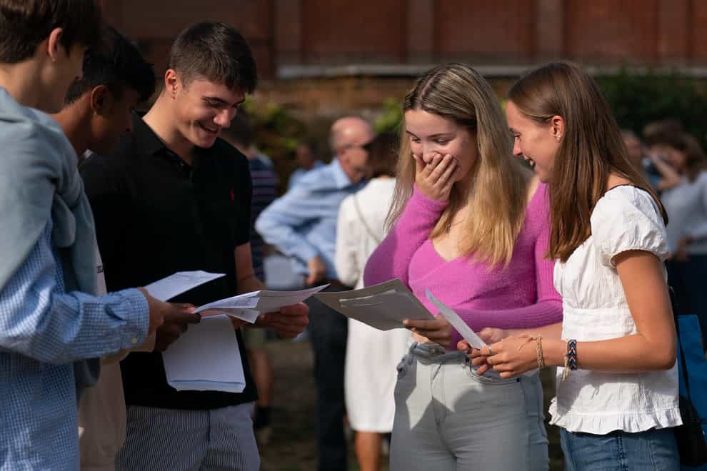 Abi Hill (right) and Anna Austin celebrate with friends as they receive their A-level results at Norwich School (Joe Giddens/PA)