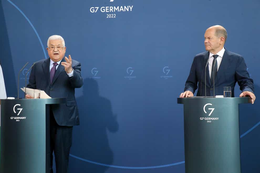 Palestinian President Mahmoud Abbas, left, speaks during a news conference after a meeting with German Chancellor Olaf Scholz, right, at the Chancellery in Berlin ( Wolfgang Kumm/dpa via AP)