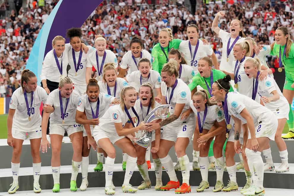 England’s Leah Williamson and Millie Bright lift the Euro 2022 trophy (Jonathan Brady/PA)