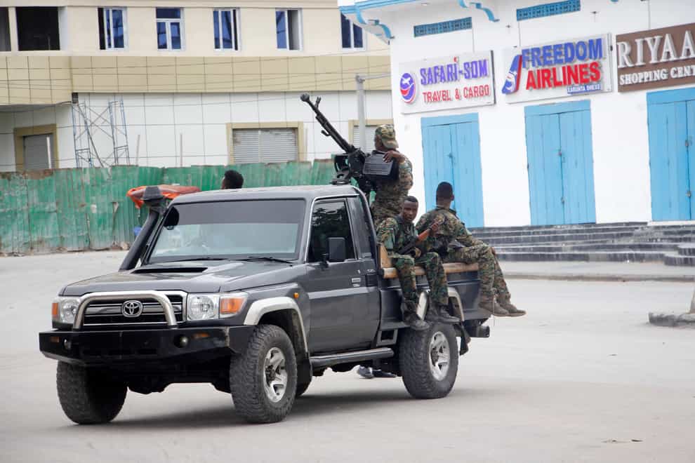 Somali soldiers patrol outside the Hayat Hotel in Mogadishu (Farah Abdi Warsameh/AP)