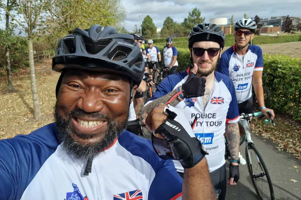 Festus Akinbusoye completing the cycle with fellow team members (Festus Akinbusoye/PA)