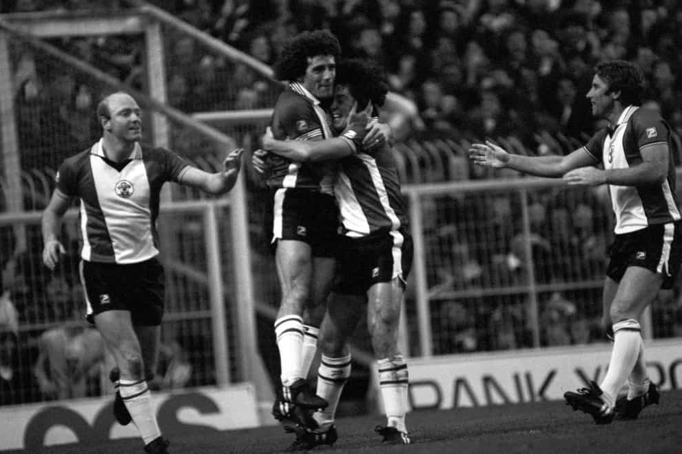 Southampton team mates congratulate each other with a hug after Kevin Keegan, centre, fired a 41 minute goal into the roof of the net putting his team 2-1 ahead. David Armstrong, left, adds his congratulations.