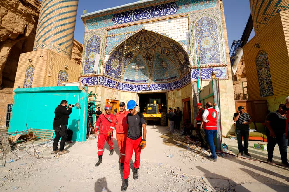 Emergency services and rescue workers are seen at Qattarat al-Imam Ali shrine near Karbala, Iraq, on Sunday August 21 2022 (Anmar Khalil/AP)
