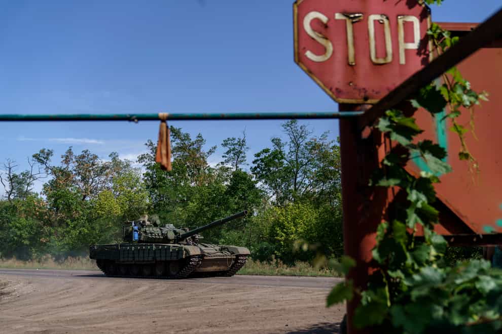 A Ukrainian military tank drives down the road in the Donetsk region, eastern Ukraine (David Goldman/AP)