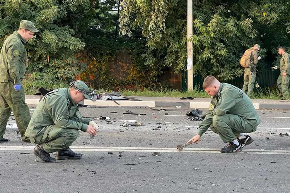 Investigators work on the site of explosion of a car driven by Daria Dugina near Moscow (Investigative Committee of Russia/AP)