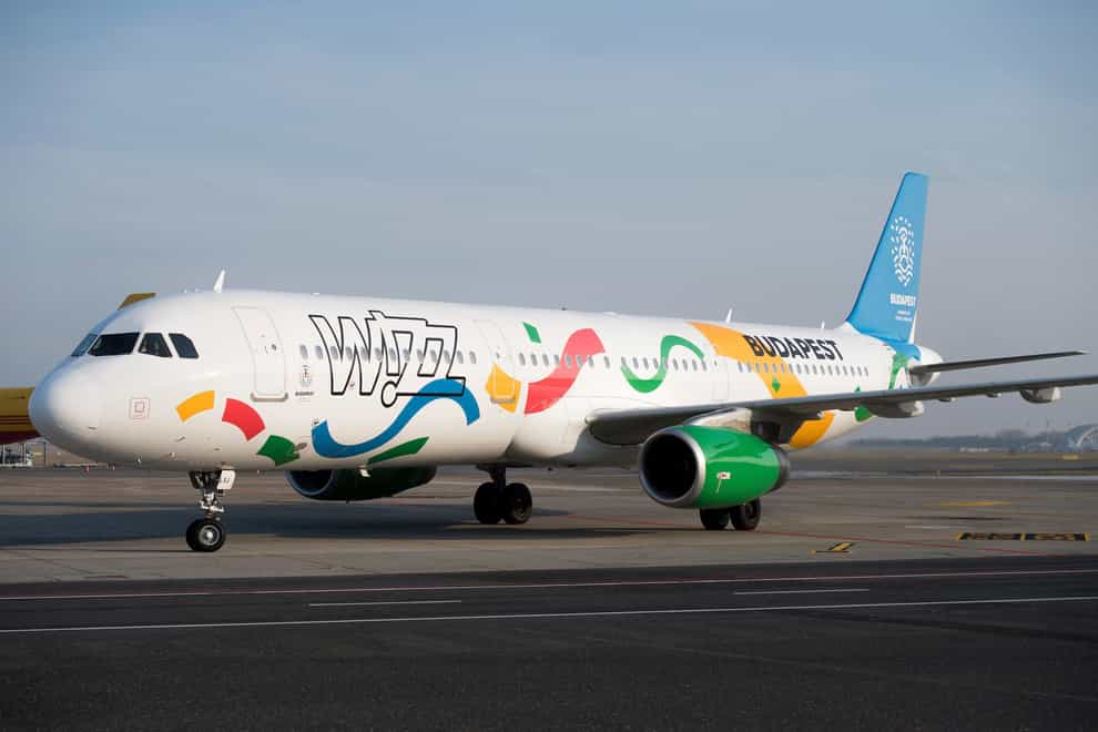 An aircraft of the low-cost of Wizz Air airlines painted in the colours of the logo of host city candidate Budapest for the 2024 Olympic and Paralympic Games is displayed in Liszt Ferenc International Airport in Budapest, Hungary (Szilard Koszticsak/MTI/AP)