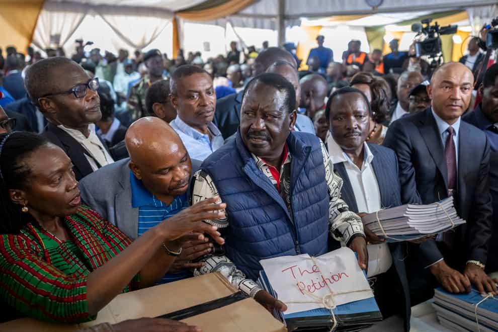 Presidential candidate Raila Odinga, centre, hands over the petition to the Supreme Court (Ben Curtis/AP)