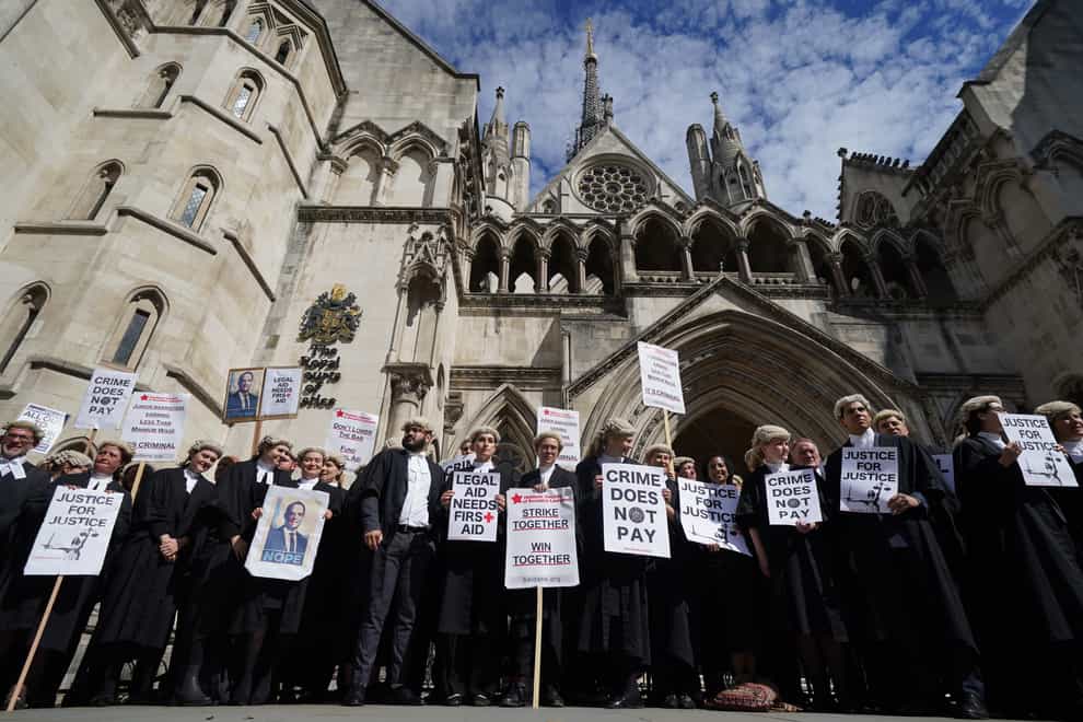 Criminal defence barristers gather outside the Royal Courts of Justice (Kirsty O’Connor/PA)