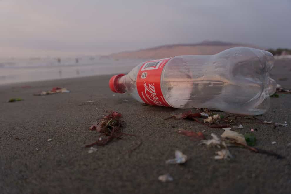 A coke bottle lying on a beach (Maria Mendiola/Surfers Against Sewage/PA)