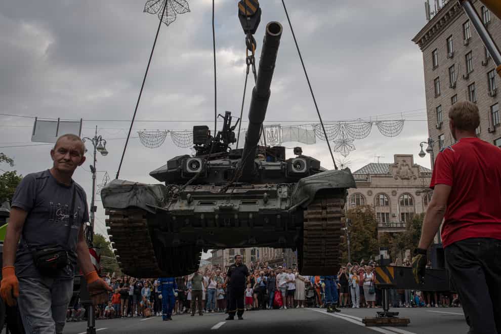 Ukrainians visit an avenue where destroyed Russian military vehicles have been displayed in Kyiv (AP)