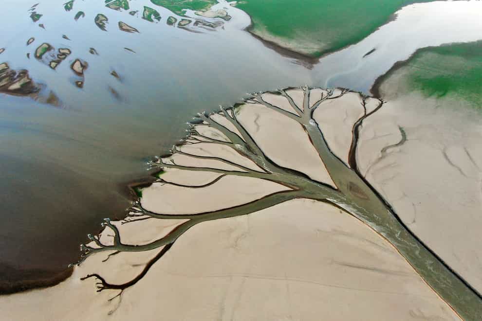Water flows through channels in the lake bed of Poyang Lake, China’s largest freshwater lake (Xinhua via AP)