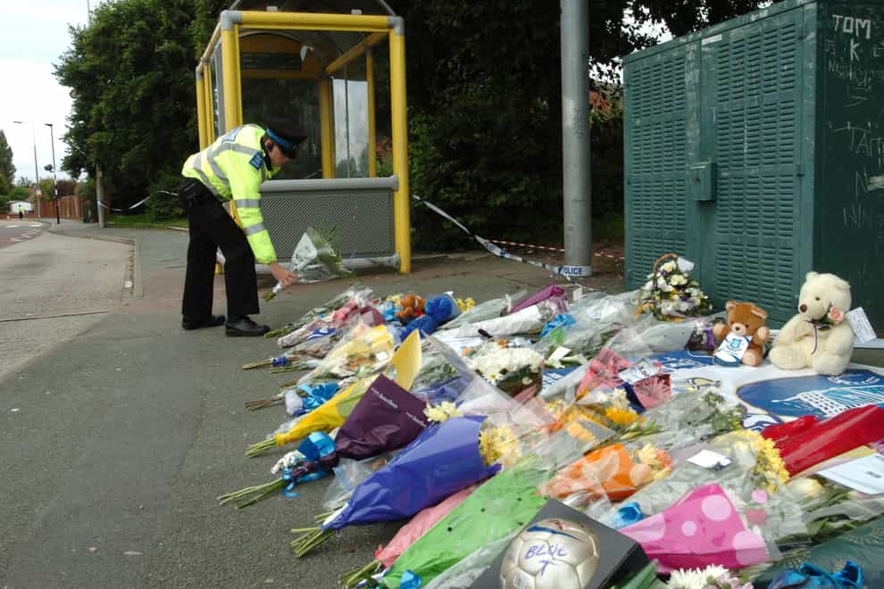 Flowers laid outside the Fir Tree pub in Croxteth Park in memory of murdered Rhys Jones (Terry Kane/PA)
