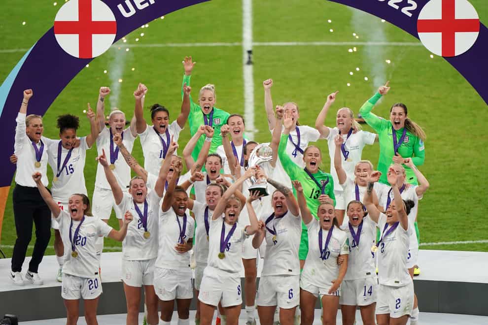 England’s Leah Williamson and Millie Bright lift the trophy (Joe Giddens/PA)