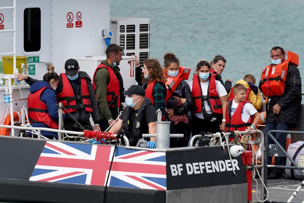 EDITORS NOTE Children’s faces have been pixelated as the PA Picture Desk has been unable to gain the necessary permission to photograph a child under 16 on issues involving their welfare. A group of people thought to be migrants are brought in to Dover, Kent, onboard a Border Force Vessel, following a small boat incident in the Channel. Picture date: Tuesday August 23, 2022. (Gareth Fuller/PA)