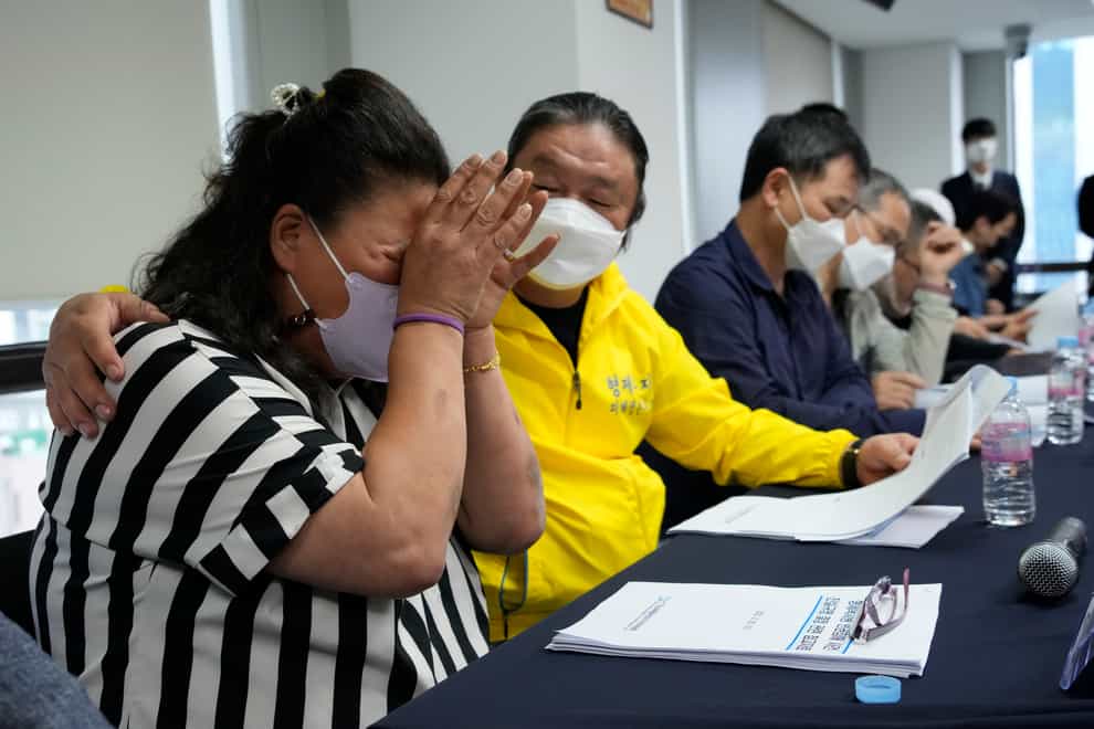 Park Sun-yi, left, a victim of abuse at Brothers Home, weeps during a press conference at the Truth and Reconciliation Commission office in Seoul, South Korea (Ahn Young-joon/AP)